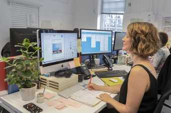 A woman working at a desk in an office