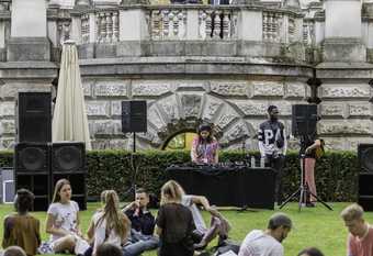 A group sits on the lawn outside Tate Britain