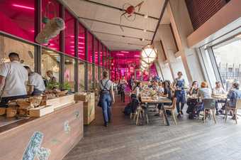 People enjoying food and drinks in Tate's terrace bar