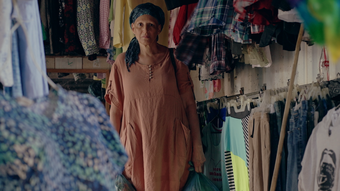 The artist Patricia Belli, surrounded by fabric.